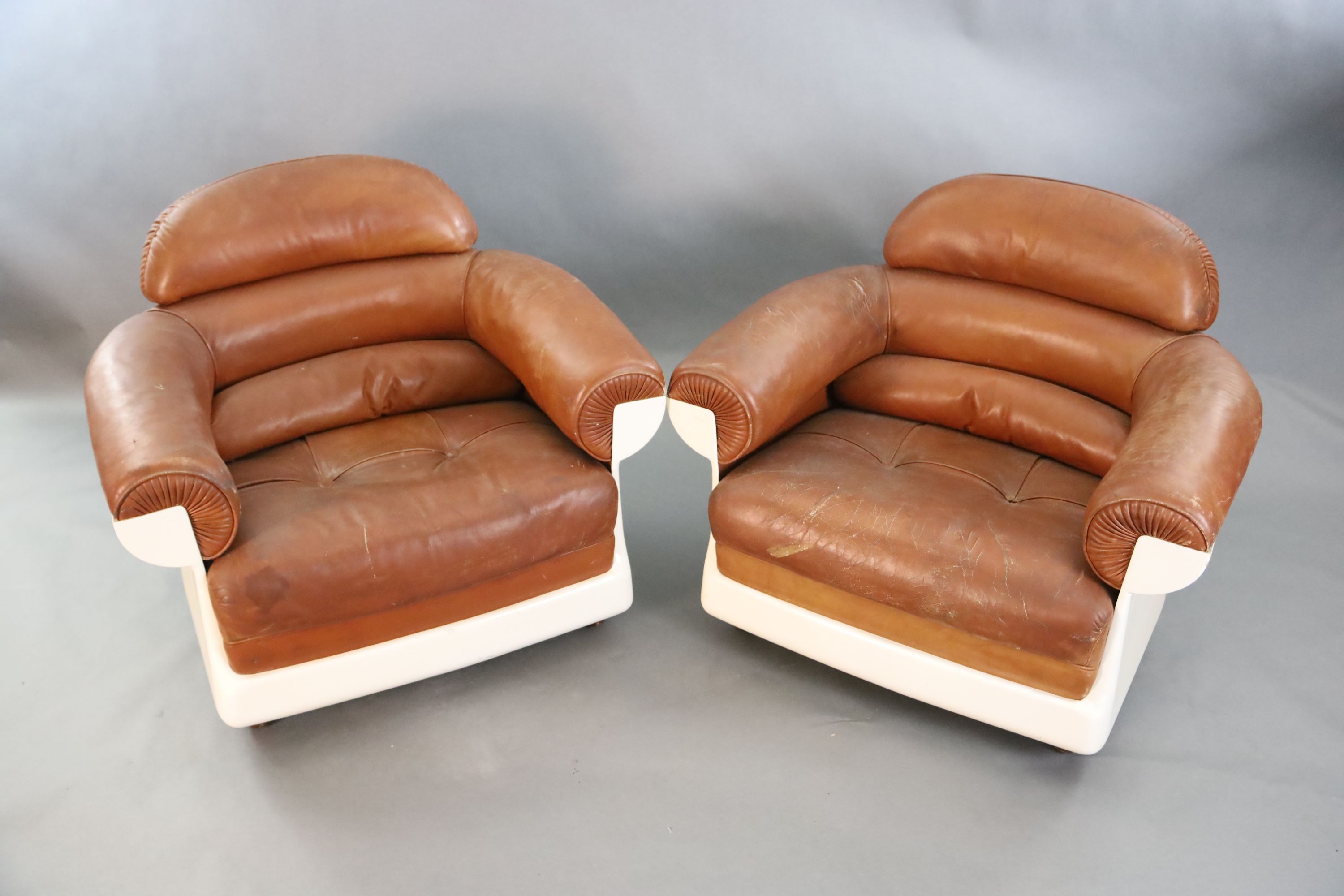 A pair of mid century tan leather and fibreglass tub chairs, possibly French, by Airbourne, W.3ft 1in. D.2ft 7in. H.2ft 8in.